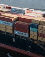 A large cargo ship loaded with containers ready for international shipping.