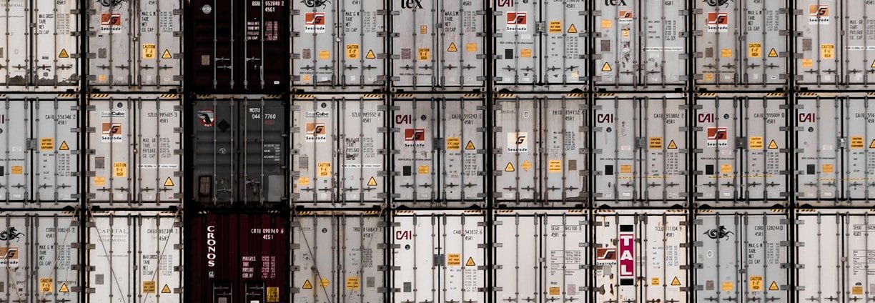 A professional team coordinating international moving logistics with global maps and shipping containers in the background.