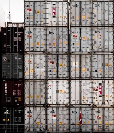 A professional team coordinating international logistics with maps and shipping containers in the background.