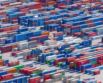 A professional team coordinating international shipments with containers and cargo planes in the background.