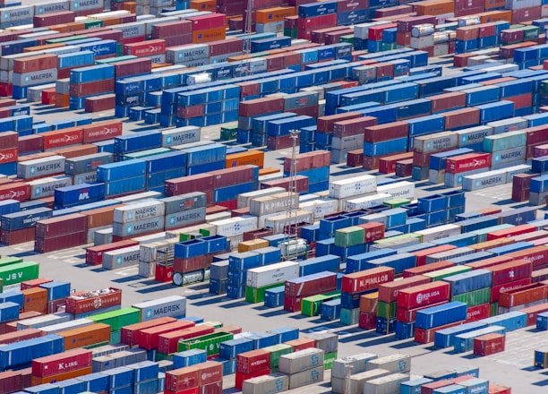 A professional team coordinating international shipments with containers and cargo planes in the background.
