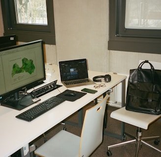 Modern office desk with a laptop showing a digital map of global logistics routes.